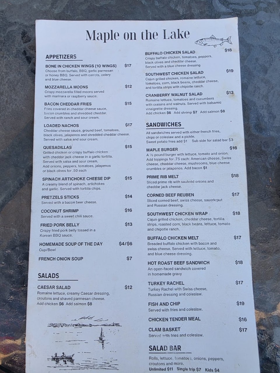 Printed menu with appetizers, salads, and sandwiches.